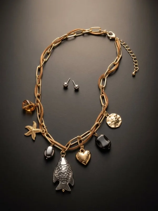 Set Ictus de Arcano: cadena dorada de eslabones anchos con pez plateado, corazón, estrella de mar y piedras